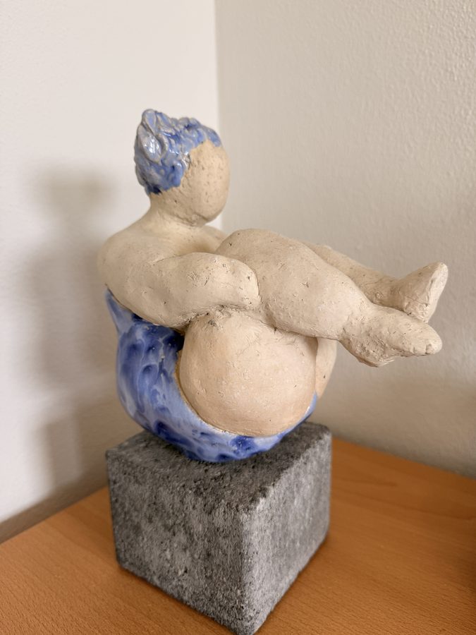 Zittende boetseerfiguur